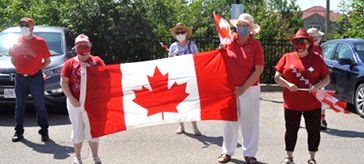 President Tammy Paglia from the Bradford Legion held a flag with friends at the lot of the Bradford Valley Care Community on Canada Day.