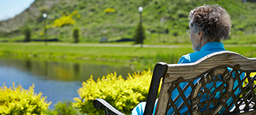 image of a female senior sitting at the beautiful garden at Kingsmere Retirement Residence