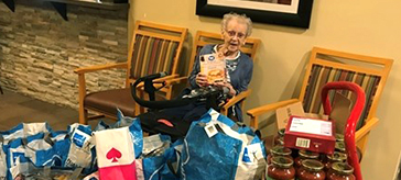 picture of resident of Cedarvale Lodge Retirement and Care Community showcase the 300lb donation 