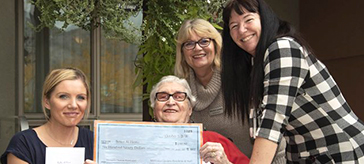 image of Mariposa Gardens resident Irene Neely (second from left), Miriam Landry, executive director (third from left), and Jannine Rennie, director of resident programs (right), presented a cheque