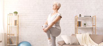 image of a female senior stretching her leg in an indoor setting