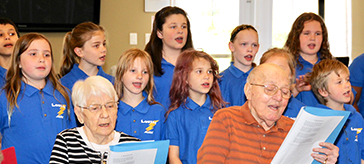 photo of the seniors of Cedarvale Lodge singing together with the students from the publish school