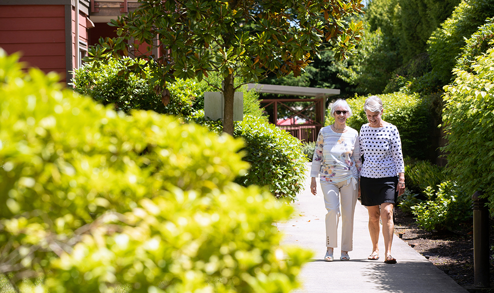 Elderly women enjoying the good weather in the garden of Pacifica retirement