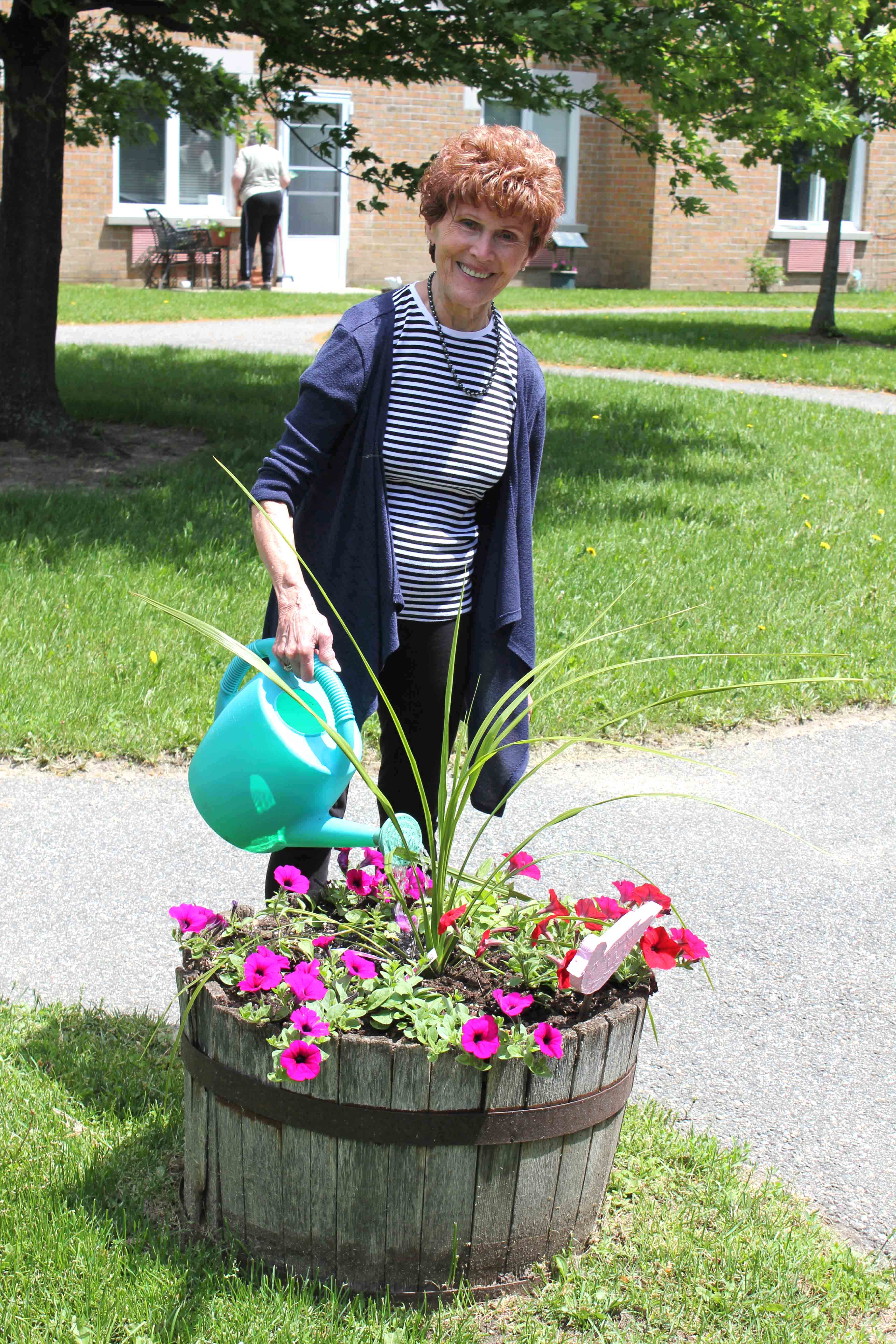 A resident watering the plants. 