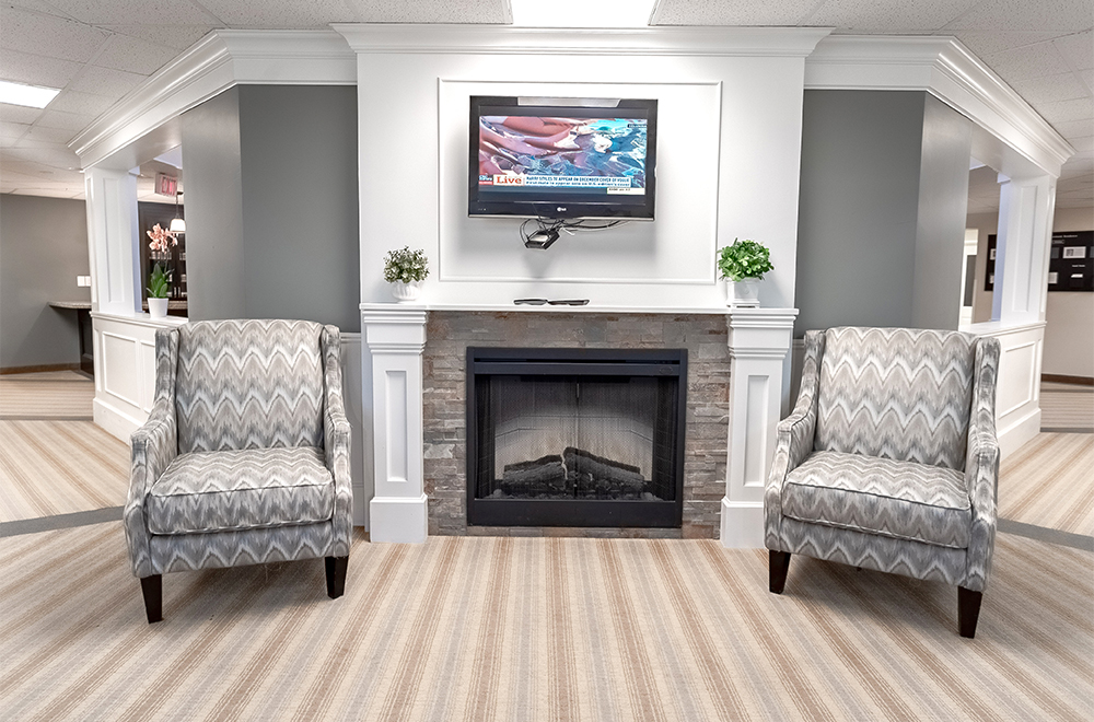 Seating area around the fireplace at Masonville Manor Retirement Residence in London