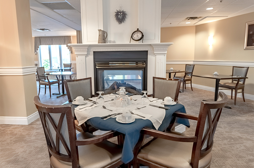 Dining table beside the fireplace at Carolina Retirement Residence in Perth near Ottawa