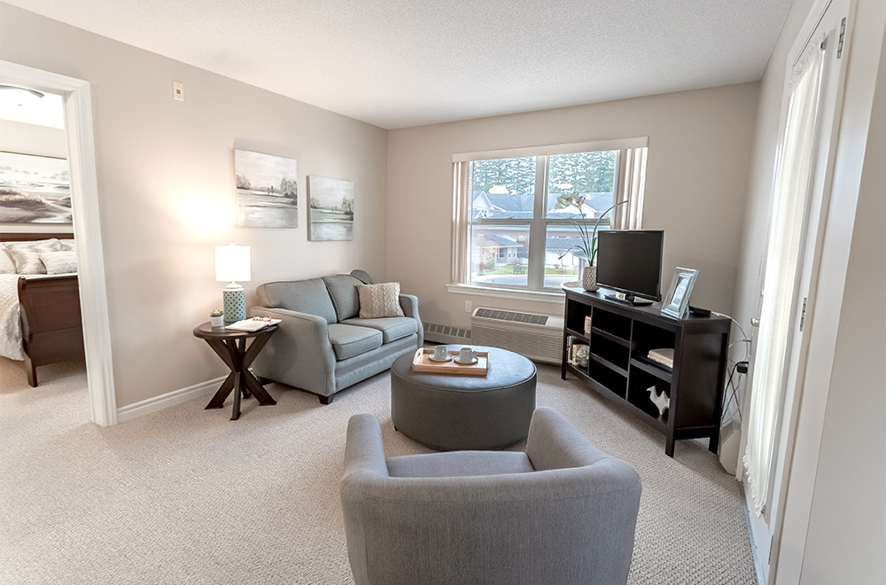 TV area and a view of the bedroom in one of the suites at Masonville Manor Retirement Residence in London
