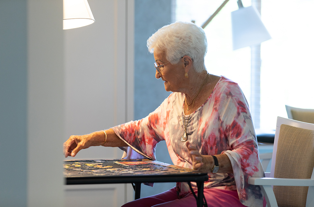 Woman putting together a puzzle