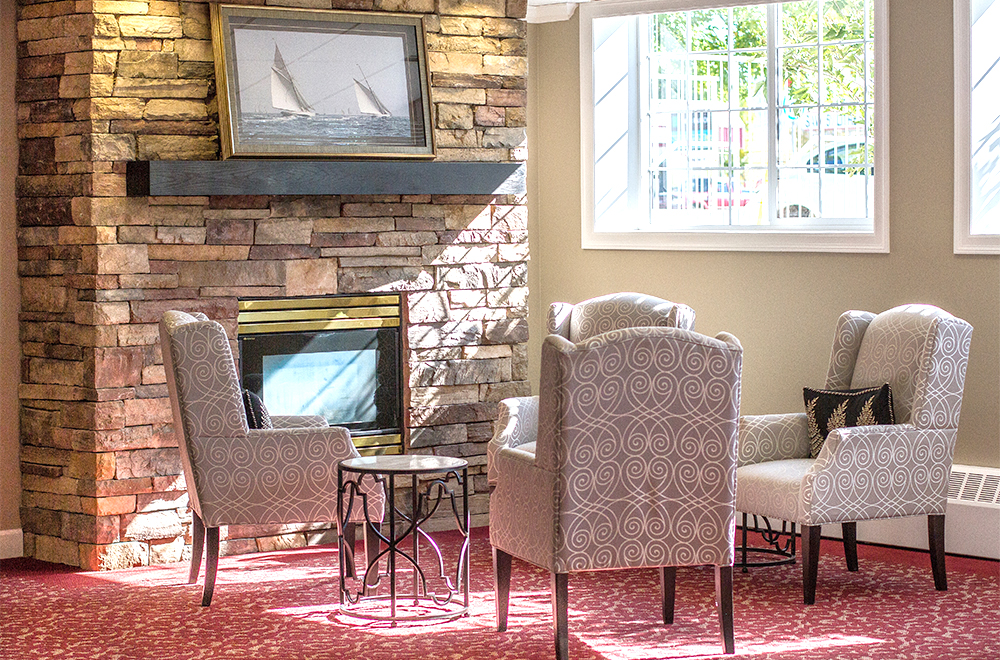 Seating area around the fireplace at The Shores Retirement Residence in Kamloops