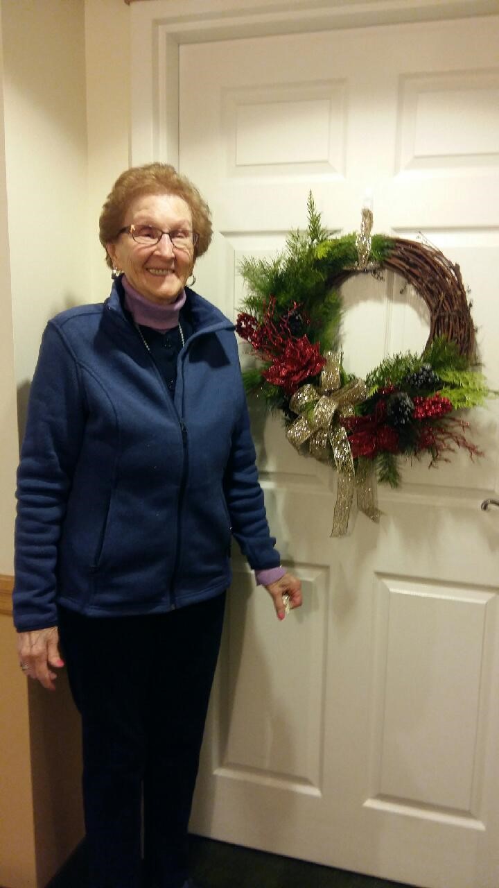 A Senior getting into the holiday spirit with festive decoration. 