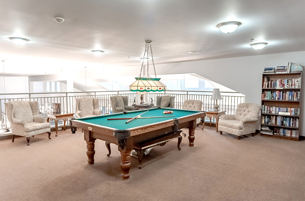 The seating area around the pool table at Fairwinds Lodge Retirement Residence in Sarnia