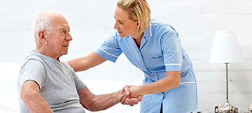 picture of a personal support worker assisting a male senior