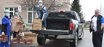 image of Bradford Lions Jamie Jones, at right, delivers the first consignment of coffee and treats for staff and care workers at Bradford Valley Care Community on Easter Sunday. 