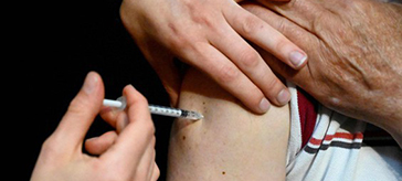 A senior receives a COVID-19 vaccine.