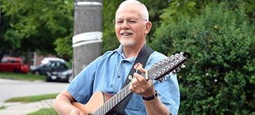 Dan Antonio with his guitar - bringing joy through his work, and his volunteer efforts. 