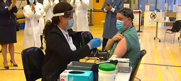 image of one of the front-line workers getting the COVID-19 vaccine