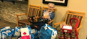 picture of resident of Cedarvale Lodge Retirement and Care Community showcase the 300lb donation 