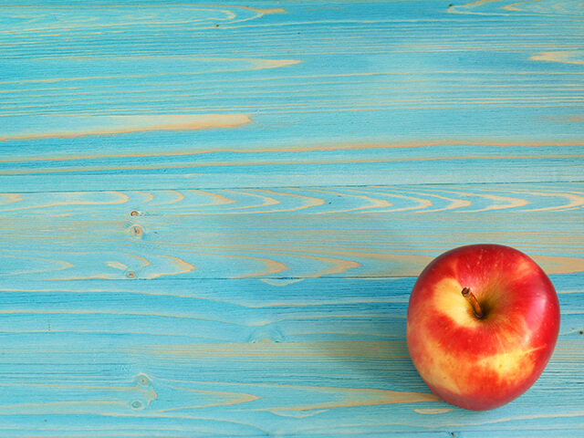 image of an apple on an ocean colour wood board