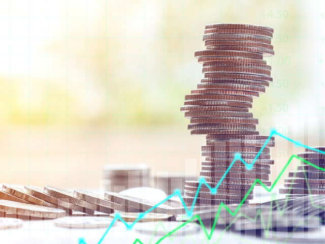 stack of coins with stock price graph shown on top of image as an overlay