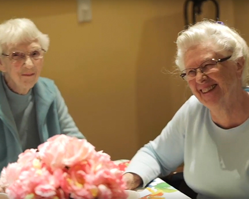 image of two happy female seniors smiling toward the camera