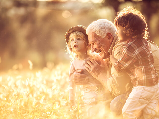 image of a playful grandfather playing with his grandchildren