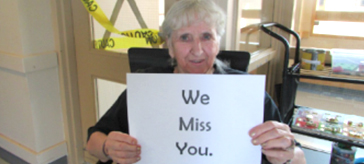 image of a female senior holding up a sign saying 