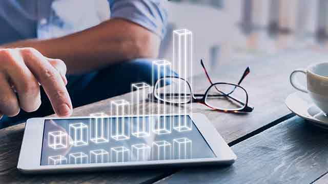 image of a man analyzing financial data through an iPad