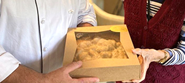 image of a chef and a resident holding the pie