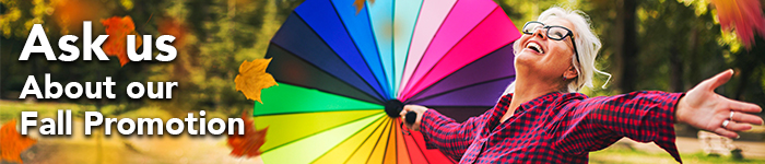 A Fall promotion web banner features a happy female senior, one hand holding a colourful umbrella and the other hand tries to catch some falling leaves.