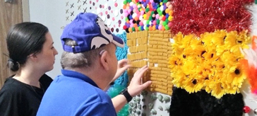 BSO Team Lead Assistant, Samantha Paterson, engages resident, Lynda in a sensory activity.