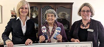 photo of Mary MacLean holding a cheque to United Way Simcoe Muskoka.
