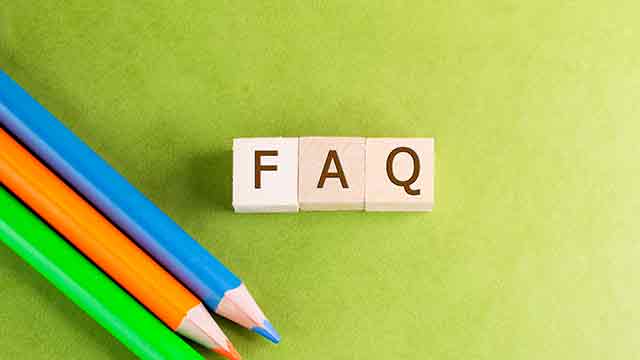 image of a FAQ conceptual photo with the letter blocks of FAQ in the middle and accompany with 3 pencil crayons in green, orange and blue on the side.
