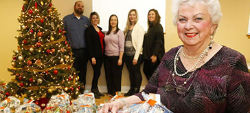image of Quinte Gardens resident Lucille Chevrier, foreground, was among the people filling and wrapping baskets of food and other items at the residence Monday, December 10, 2018 in Belleville, Ont.