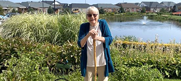 image of a female senior having fun gardening