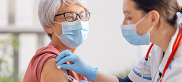 A senior receives a COVID-19 vaccine.