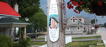 photo of Meghan Kuipers, a guest attendant at Kawartha Lakes Retirement Residence painted a paddle to display in downtown Bobcaygeon to support the Vibrant Village project.