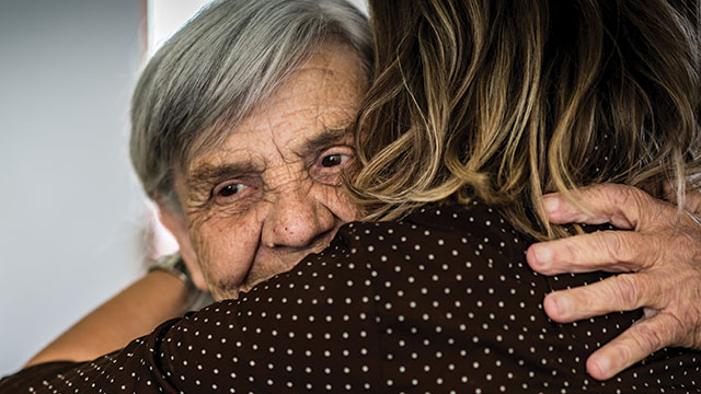 Elderly woman hugs daughter
